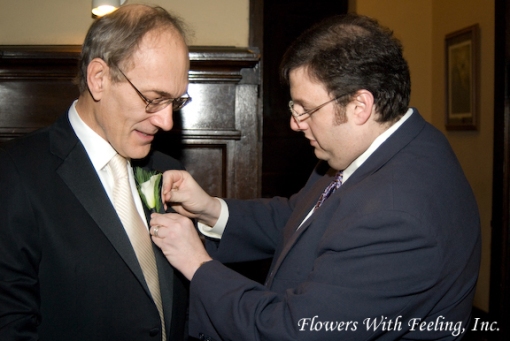 Frank Andonoplas of Frank Event Design assists groom with boutonniere pinning. (Photography by Bartelt Studios Photography) 